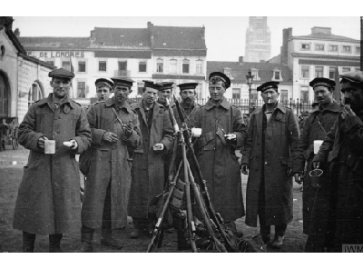 RND in a town square with their rifles stacked